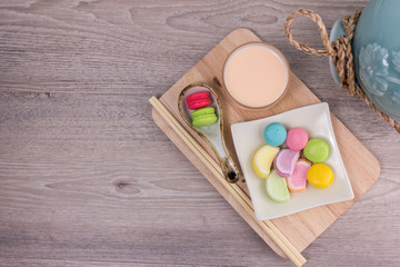 Sweet colorful macaroons on a wood background