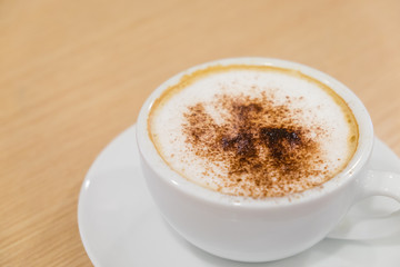 Coffee in white cup on wood table