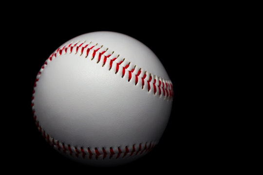 Baseball in black background.