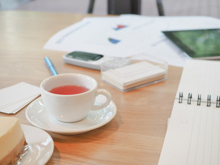 A glass of tea on the desk.