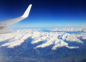 Naklejka na ściany i meble Swiss and French Alps covered in snow - Aerial view