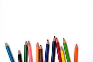 Color pencils on white background, copy space.