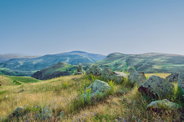 The ancient astrologica observatory Karahunj in Armenia. "Armenian Stonehenge". View of the mountains and the blue sky.