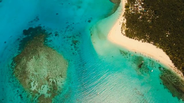 Aerial view of beautiful tropical island Daco with white sand beach. View of a nice tropical beach from the air. Beautiful sea, resort. Seascape: Ocean and beautiful beach paradise. Philippines. 4K