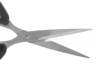 Scissors cutting a paper on the white background.