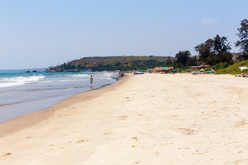 Sea view and tropical sandy beach with sunny sky. Goa, India.