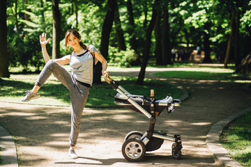 Series of exercises with a stroller - young gorgeous mother with baby stroller workout in the park. Sport, maternity, healthy lifestyle concept