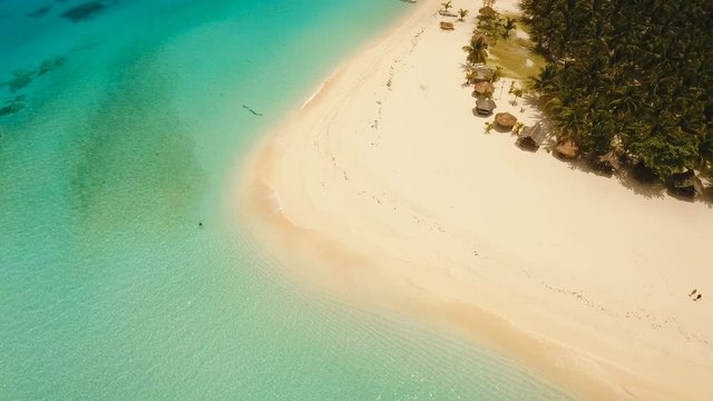 Aerial view of beautiful tropical island Daco with white sand beach. View of a nice tropical beach from the air. Beautiful sea, resort. Seascape: Ocean and beautiful beach paradise. Philippines. 4K