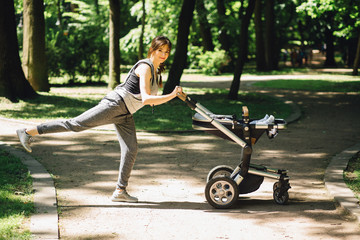 Series of exercises with a stroller - young gorgeous mother with baby stroller workout in the park. Sport, maternity, healthy lifestyle concept