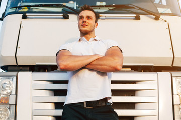 Portrait of Young Muscular Man Driver in White T-shirt Standing Near Truck, Trucker Concept