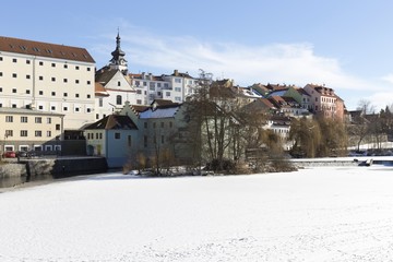 Colorful royal snowy medieval Town Pisek above the frozen river Otava, Czech Republic 