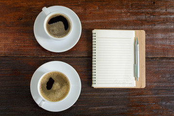 coffee cup clock and news paper on old wooden table nature background