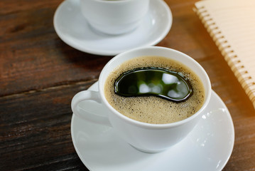 coffee cup clock and news paper on old wooden table nature background