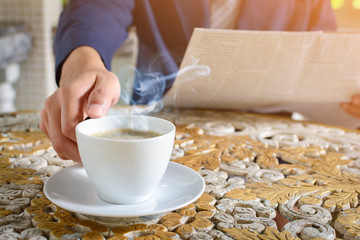 coffee cup clock and newspaper work on table