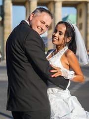 Smiling newlywed couple at Brandenburger Gate in Berlin © arianarama