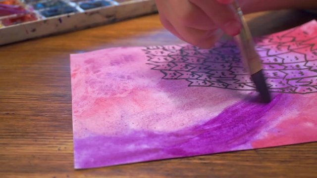 Close up hd video girl's hand with brush drawing watercolour 