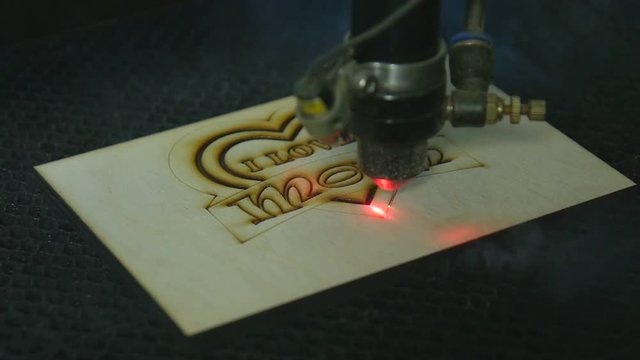 Laser cutting machine at work on wood
