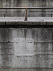 background concrete wall detail with tubular iron bar