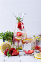 Cold fresh  homemade  lemonade with strawberry and herbs. Detox soda water recipe