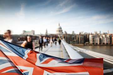union jack flag and people walking on Millennium bridge at St Paul's cathedral - general elections,...