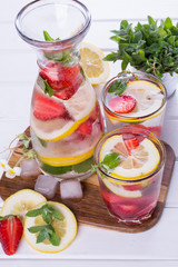 Cold fresh  homemade  lemonade with strawberry and herbs. Detox soda water recipe