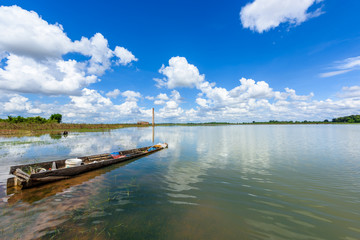 Fototapeta na wymiar landscape of lake and fishing boat with blue sky