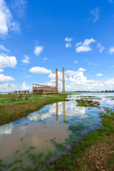 Landscape of Old mill in the reservoir against blue sky