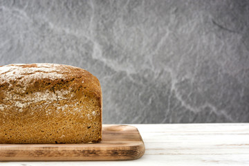 Bread on white wooden background.
