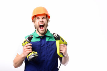Brutal working man shouts and holds yellow building tools