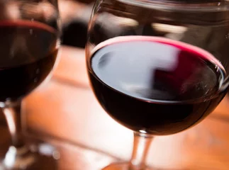 Fotobehang Blurred red wine background. Selective focus. © vladhhe