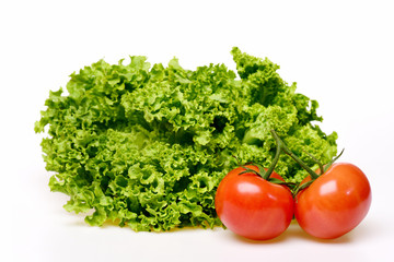 diet concept, leafy vegetables or lettuce leaf with tomatoes