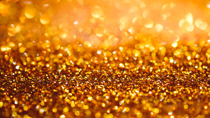 Gold light bokeh texture or glitter lights festive gold background. Christmas abstract template