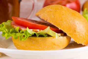 Homemade sandwich with ham, tomato and lettuce