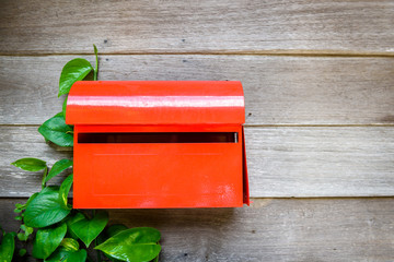 Red mailbox on the wooden wall