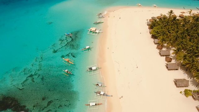 Aerial view of beautiful tropical island Daco with white sand beach. View of a nice tropical beach from the air. Beautiful sea, resort. Seascape: Ocean and beautiful beach paradise. Philippines. 4K
