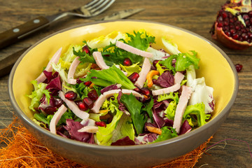 Salad mix with ham and pomegranate seeds