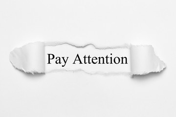 Pay Attention on white torn paper