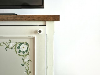 Closeup wood cabinet in vintage style on the white wall. Interior room decoration in retro concept