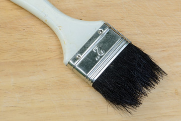 paint brush on a wooden surface