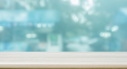 Empty wooden table top with blur coffeeshop window background, panoramic banner.