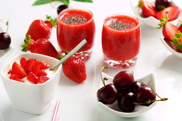 delicious desserts with strawberries and sweet cherry smoothies, curd, yogurt on a white background.