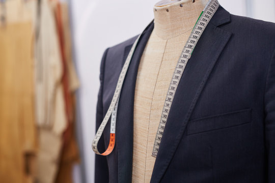 Custom made tailored suit on mannequin in atelier studio