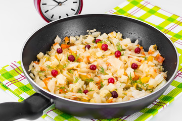 Stewed cabbage in frying pan with vegetables