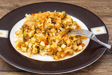 Fried cabbage with onions and paprika on plate