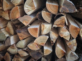 Stack of chopped firewood logs background.