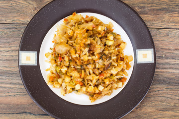 Fried cabbage with onions and paprika on plate