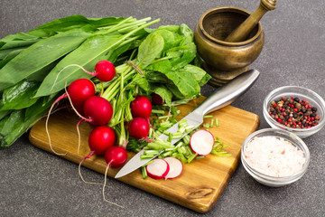 Spring greens radishes and wild garlic, sliced for vegetarian sa