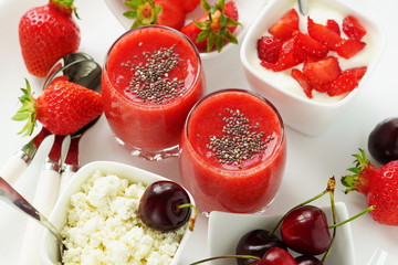 delicious desserts with strawberries and sweet cherry smoothies, curd, yogurt on a white background. Top view
