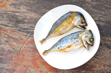 fried Mackerels on old wooden table