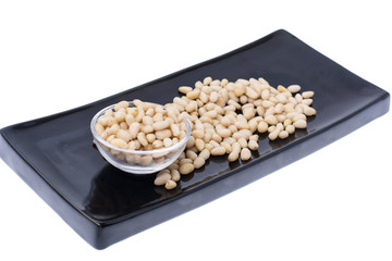 Peeled pine nuts on white background